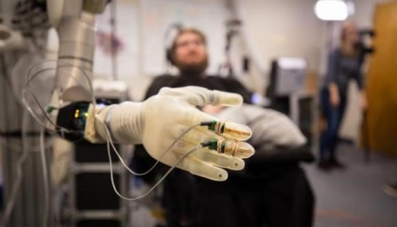A patient controls a robotic arm