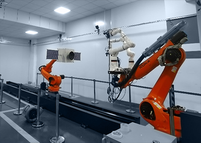 A robotic arm equipped with a vision sensor and a robotic arm equipped with a spacecraft model under the motion capture system